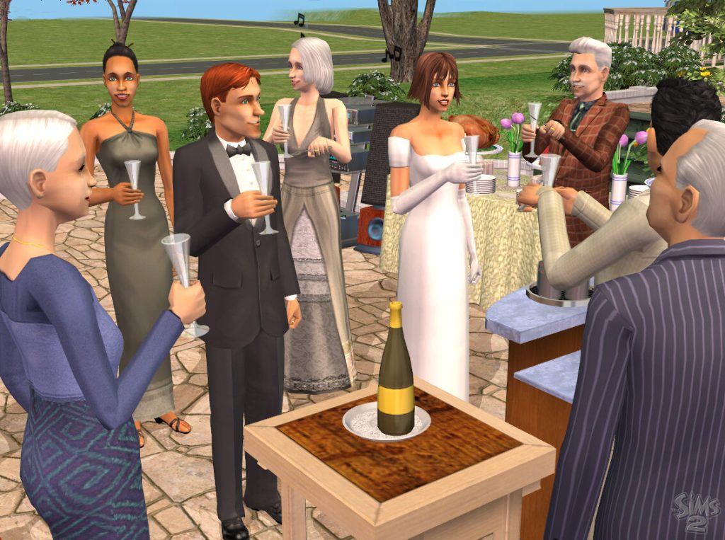 Screenshot of The Sims 2 showing an outdoor wedding reception on a stone patio during the daytime. A group of Sims dressed in formal attire, including a Sim in a white wedding dress and another in a black tuxedo, are gathered around holding champagne glasses for a toast. A champagne bottle rests on a small wooden table in the foreground. In the background, there is a buffet table with food and a speaker system with musical notes floating above it. The classic The Sims 2 logo is visible in the bottom right corner.