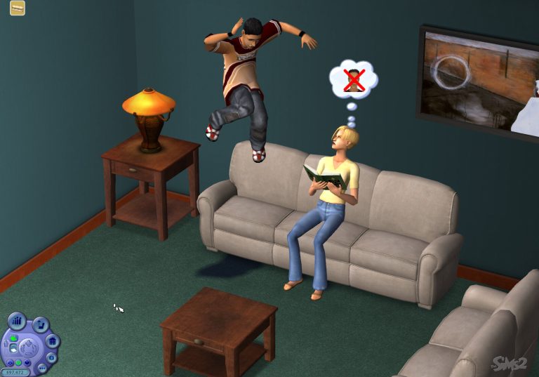 Screenshot of The Sims 2 showing an indoor living room. A Sim with short blonde hair is sitting on a beige couch reading a green book, with a thought bubble displaying a red 'X' over a face. Behind them, another Sim is caught in mid-air, jumping off the back of the couch. The room features green carpet, and the game's user interface is visible in the bottom left corner.