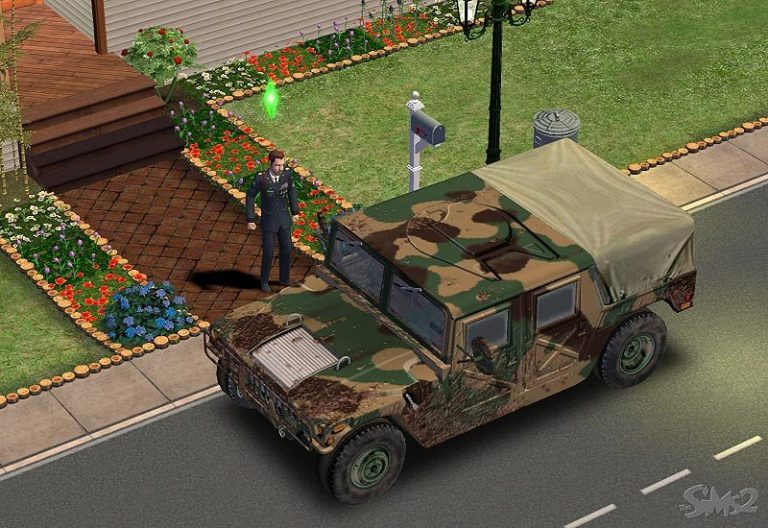 Screenshot of The Sims 2 showing a male Sim in a dark military uniform standing next to a large camouflaged military vehicle parked on the street. He is standing on a sidewalk in front of a house with a brick path and flower beds, and there is a green Plumbob floating above his head.
