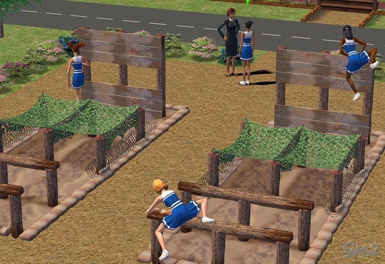 Screenshot of The Sims 2 showing several female Sims in blue athletic outfits training on a wooden outdoor obstacle course. One Sim is climbing over a wooden wall while another crawls under a camouflage net. An adult female Sim in a dark suit stands nearby watching them.