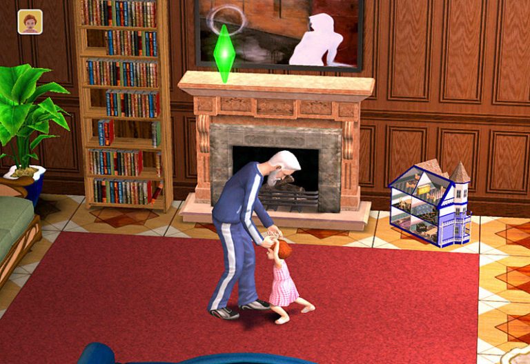 Screenshot of The Sims 2 showing a cozy living room with wood-paneled walls. An older Sim in a blue track suit is holding the hands of a toddler Sim in a pink dress, teaching them how to walk on a large red rug. A fireplace, a tall bookshelf, and a dollhouse are visible in the background, with a green Plumbob floating above the older Sim.