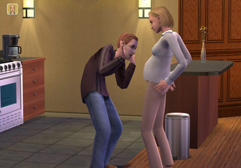 Screenshot of The Sims 2 showing a kitchen with two Sims. One Sim is visibly pregnant, wearing a light blue top and tan pants. The other Sim is bending down, holding a hand to their ear to listen to the pregnant Sim's belly.