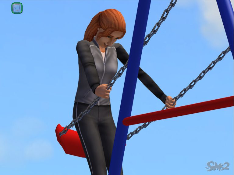 Screenshot of The Sims 2 displaying a female Sim with red hair happily swinging on a playground swing set. She is wearing a grey and black athletic tracksuit and is gripping the metal chains of the red swing seat, which is suspended from blue poles. The background features a bright, clear blue sky, and the classic Sims 2 logo is visible in the bottom right corner.