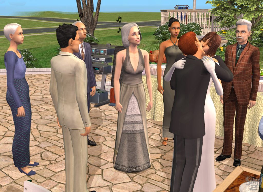 Screenshot of The Sims 2 showing an outdoor wedding party on a stone patio during the daytime. In the center, two Sims are embracing and kissing; one is wearing a black suit and the other is in a white wedding dress with white gloves. Several other Sims dressed in formal attire, including suits and long dresses, are gathered around watching the couple. In the background, a stereo system is visible with musical notes floating in the air, along with green grass and trees. The classic The Sims 2 logo is in the bottom right corner.